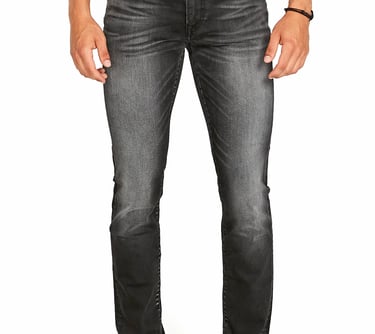 a man standing in a white shirt and jeans