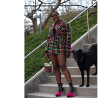 Woman posing with a black dog 