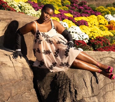 Woman posing in front of fall flowers 