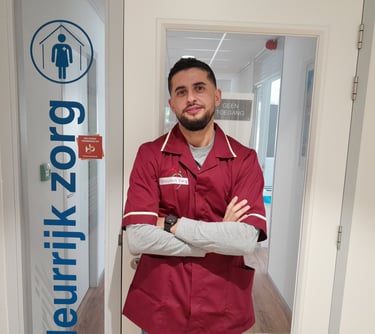a man in a red jacket standing in front of a door