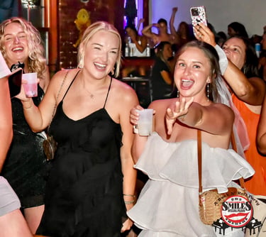 Group celebrating a bachelorette party at Savannah Smiles, a popular dueling piano bar known for liv