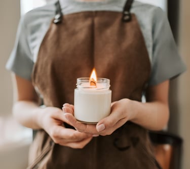 a woman holding a candle in her hands