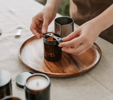a person is holding a bottle of coffee and a cup of coffee