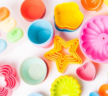 a variety of colorful plastic cupcakes and cake pans