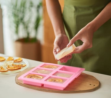 a woman in a green apron is holding a slice of cheese