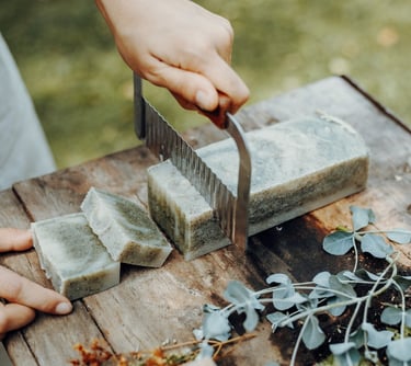 a person cutting a block of soap with a knife