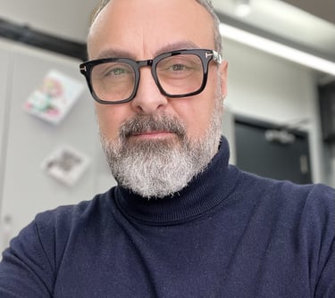a man with a beard and glasses on a desk