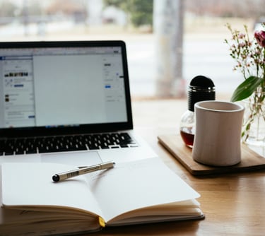 Photo of a desk with a laptop and mug