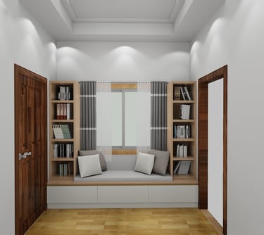 Modern reading nook with window seat, built-in bookshelves, and gray pillows in a white room.