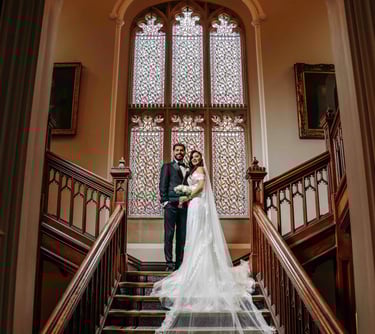 Bride and groom standing on grand staircase – Oxford wedding photo by Fred Art Studio