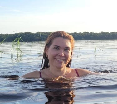 a woman in a bikini top is smiling and holding a frisbee