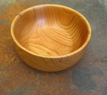 a wooden bowl with a wooden bowl on the floor