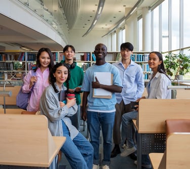 Diverse group of college students standing together in a modern university library study space.