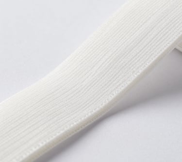 Spools of knitting yarn in rich hues displayed against a sleek black background.