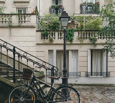 a bicycle parked next to a staircase with a lamp post