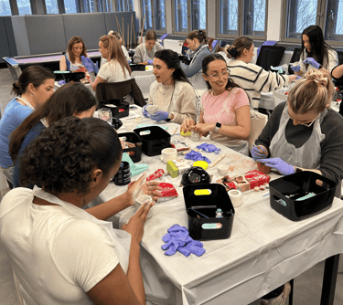 group of women making clay boob pots