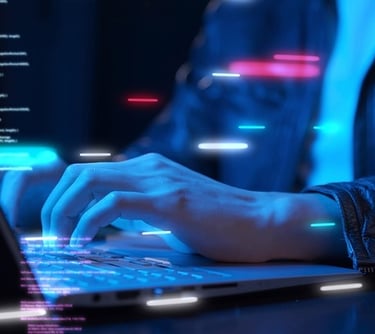 A programmer writing code on a laptop