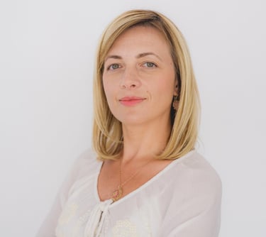 a woman with blonde hair and a white shirt