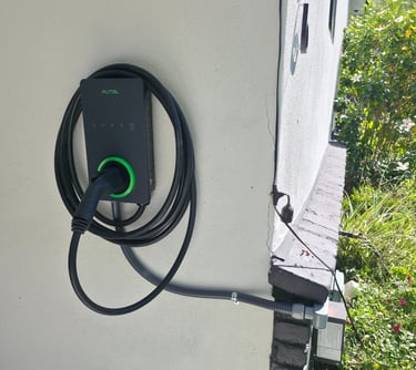 Autel wall-mounted electric vehicle charging station with cable installed on a residential exterior wall.