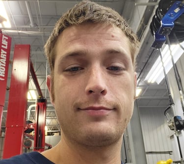 a man in a blue shirt is looking at the camera