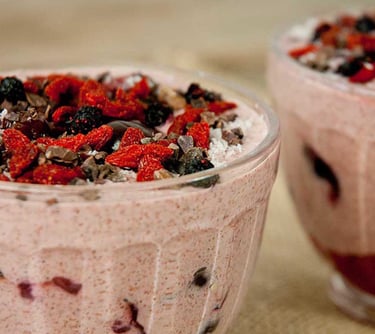 two cups of fruit and chocolate pudding in a glass