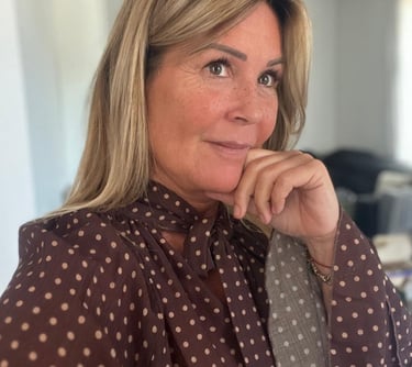 a woman with blonde hair and a polka dotty blouse