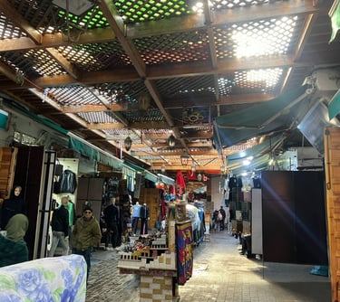 a man standing in a market place with a lot of people