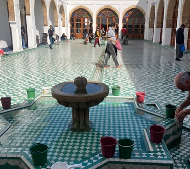 a man doing ablution in a courtyard