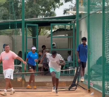 Coach Cesar working with ITF player