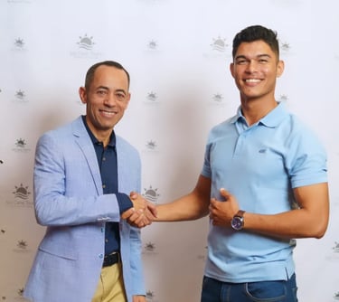 two men shaking hands in front of a wall with a wallpapered wall punta cana