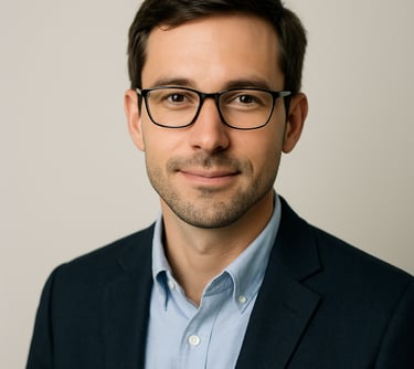 A professional headshot of a male in business casual attire, looking approachable and intelligent. Clean lighting, minimalist off white background. North American / International.