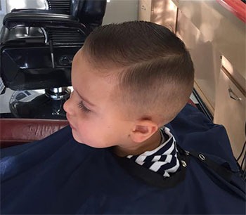 A young boy haircut at Main Street Barber
