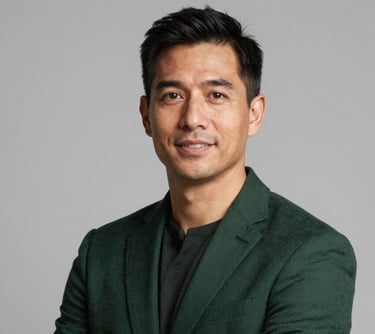 Professional studio headshot of an executive leader in North American / US (Georgia), looking approachable and professional. The lighting is bright, and the person is wearing a dark green business jacket.