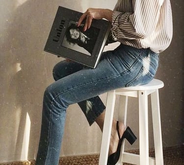 1. Mulher elegante sentada com uma revista, representando clareza e confiança após a consultoriao