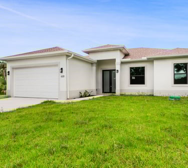 Beautifully designed front elevation of a new home for sale in Lehigh Acres, Florida. 3 beds + den, 