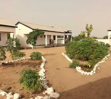 A welcoming view of the Morgan Kunda Lodge, featuring well-appointed thatched-roof bungalows set ami