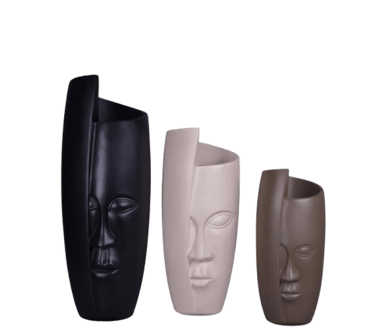 three different colored ceramic masks on a black background