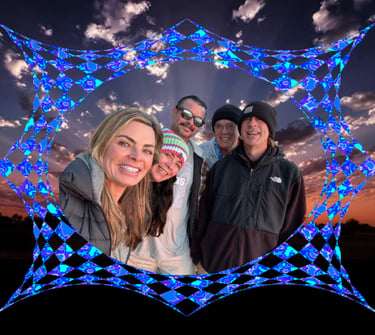 Happy group of friends posing for a photo against a sunset sky with a blue geometric overlay.