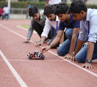 Excited students showcasing their drone flying skills outdoors