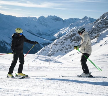 Private ski instructor teaching an adult skier in Crans-Montana