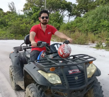 Bhargav sitting on an ATV at a beach in Indonesia