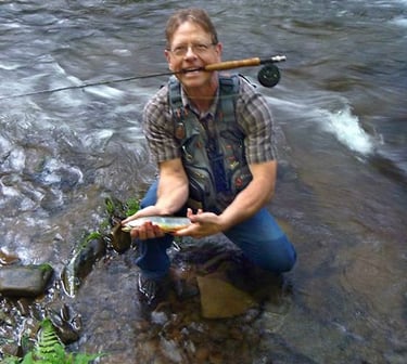 Photo of Robert E. Saunders with flyrod and trout