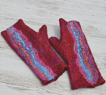 Pair of handmade red wet felted fingerless gloves with blue and pink textured silk accents 