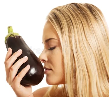 blonde, white woman smelling an eggplant