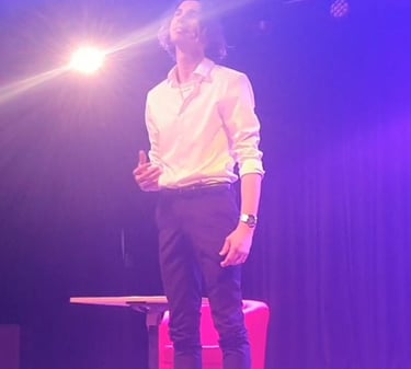 a man standing on a stool with a microphone