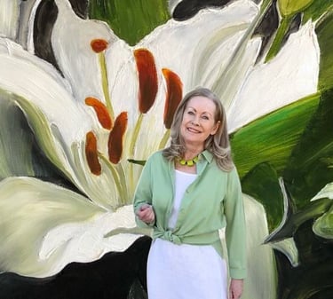 Sandra Forzani showcasing a painting of a white lily