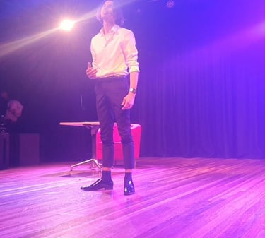 a man standing on a stool with a microphone