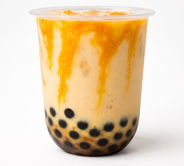 Mango bubble tea with black tapioca pearls and fruit syrup drizzle in a cup