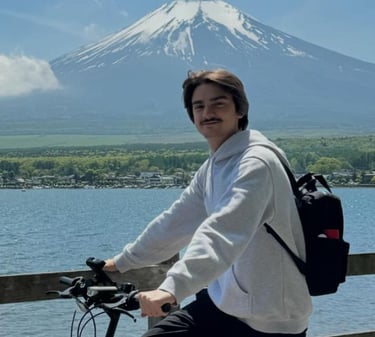 a man riding a bicycle with a backpack on it