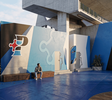 Modern blue outdoor event space with abstract logo walls and people sitting on wooden benches.
